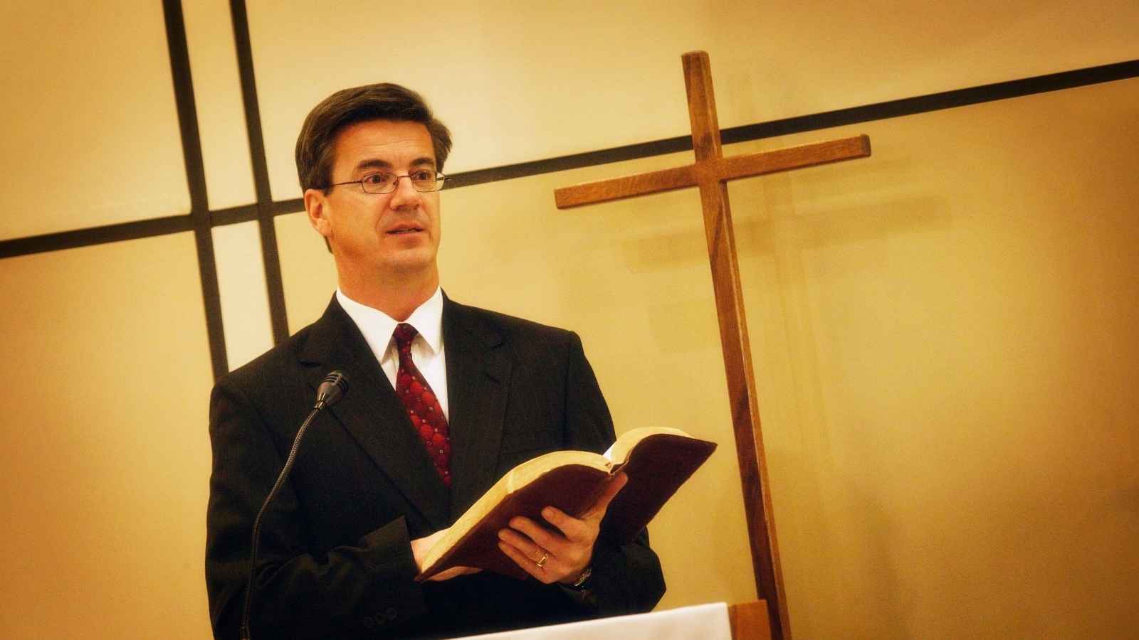 A Pastor preaching in a church.